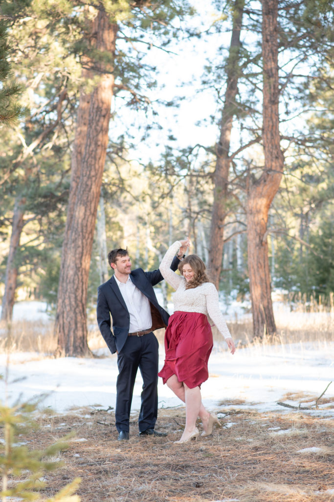 Couple dancing at Alderfer Three Sisters during winter engagement session 