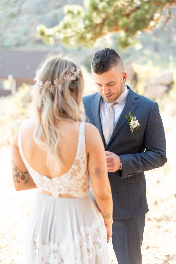 Estes Park, Colorado summer elopement bride and groom read vows during first look