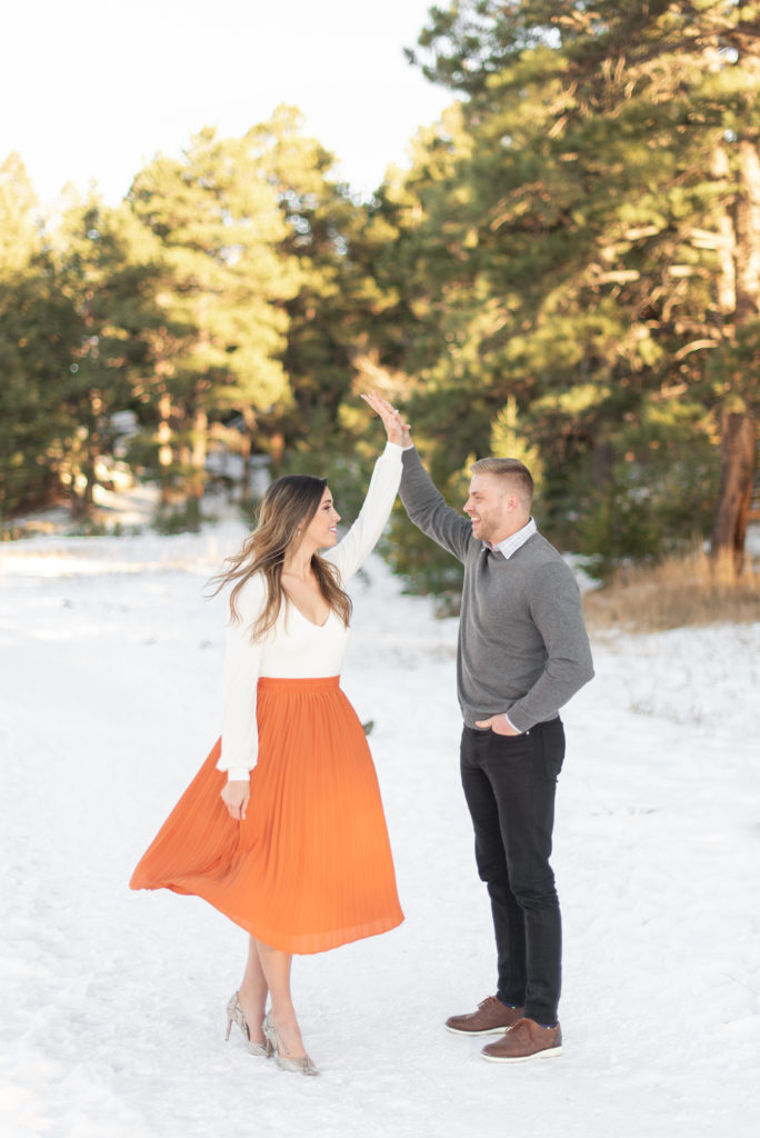 December engagement photos in Evergreen, Colorado. Alderfer/Three Sisters Park. Dancing in the snow